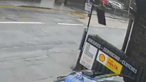 CCTV image of street where man hole cover explodes