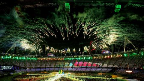 Fireworks over the London Stadium during the London 2012 Olympics with athletes in the stadium as part of the closing ceremony