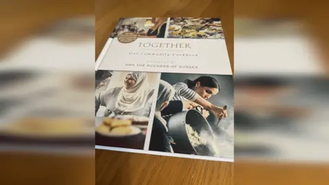 Photo of the cookbook titled "Together: Our Community Cookbook"