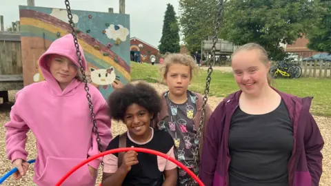 Four children playing at an activity centre in Gloucester
