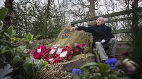 Danny Lawson/PA Tony Foulds sits by a memorial in Endcliffe Park