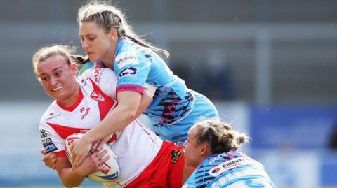 Luci McColm of St Helens is tackled 