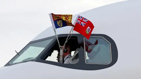 Reuters A view of flags in the cockpit of the airplane carrying Britain's King Charles.