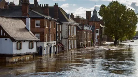 Flooded street with the water line high on properties in York