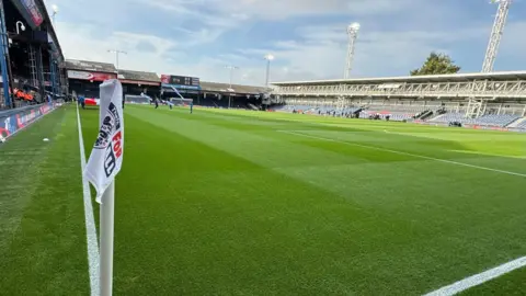 Henry Winter Kenilworth Road, Luton, showing a FA corner flag on the football pitch