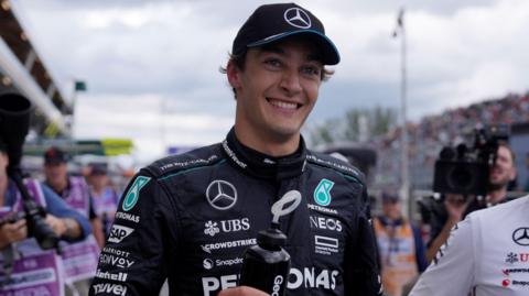 George Russell smiles after taking pole position for the Canadian Grand Prix
