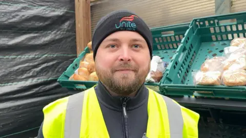 Orion Phillips wearing a high-vis jacket looking at the camera.