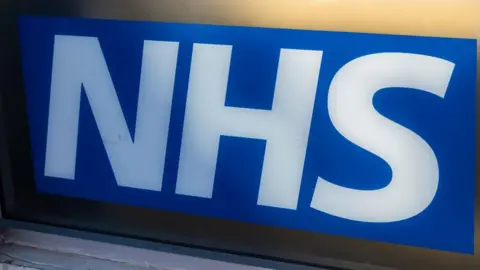 Getty Images The NHS logo - the word written in a white font on a blue background