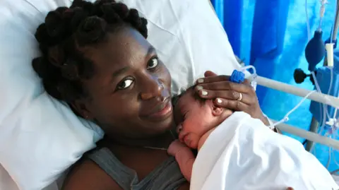 NHS Blood and Transplant Princess Green and her child in hospital