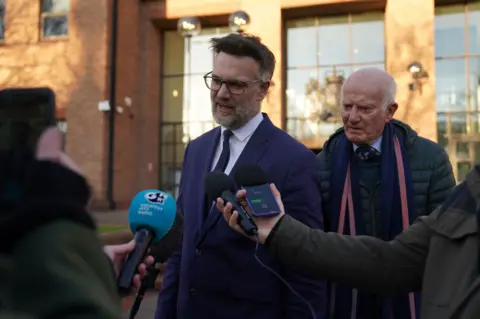 PA Media Charles Hanson talking to journalists outside court.