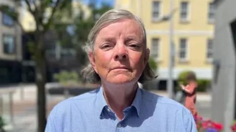 Deputy Charles Parkinson - an older man with grey hair, wearing a blue shirt. 