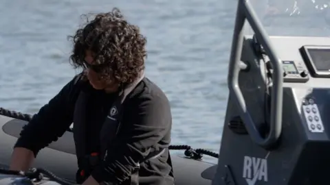 A young man aboard a RIB speedboat