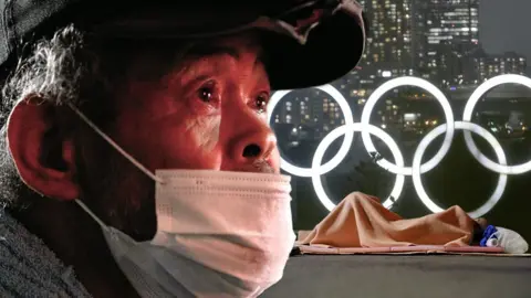 Homeless man in front of Olympic rings