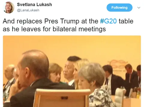 Twitter/@LanaLukash Tweet from @LanaLukash with a photo of the table: "And replaces Pres Trump at the #G20 table as he leaves for bilateral meetings"