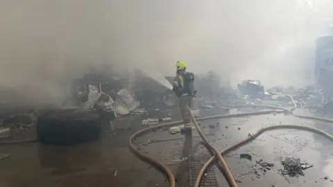 West Midlands Fire Service A firefighter at the scene