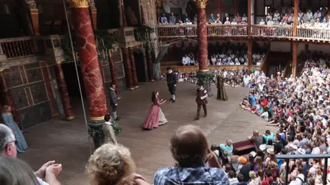 Getty Images Audience members watch a production of A Midsummer Night's Dream at Shakespeare's Globe theatre