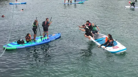 Cornwall Hugs Grenfell paddleboarders