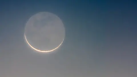 Getty Images Crescent moon with the dark part of the Moon slightly illuminated by earthshine