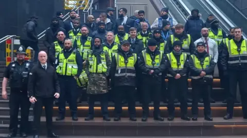 Avon and Somerset Police Police and security staff standing on the steps at Cabot Circus shopping centre in Bristol