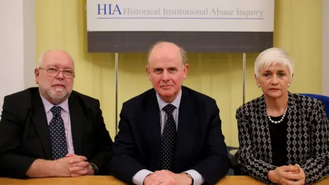 Paul Faith/PA Sir Anthony Hart, centre, with David Lane, and Geraldine Doherty at the start on the inquiry in 2014