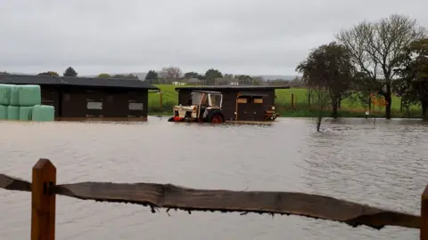 PA Media Flooded fields in Barnham, West Sussex.