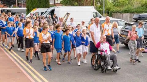 Getty Images Glyn Bennett takes part in The Queen's Baton Relay as it visits Uttoxeter as part of the Birmingham 2022 Queens Baton Relay on July 20, 2022 in Uttoxeter