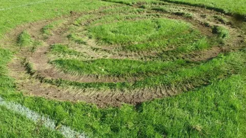 Emma Blount Tyre tracks on football pitch