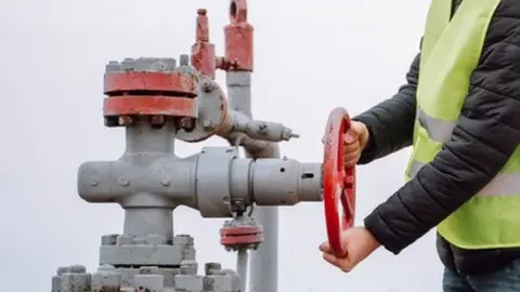 Getty Images Man turning off gas vent