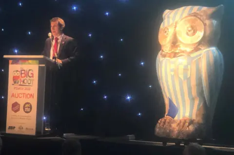 Mark Murphy/BBC Man behind lecturne next to Big Hoot owl