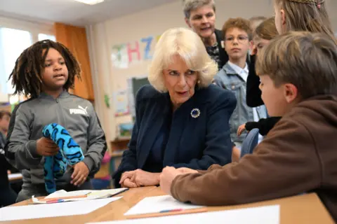 EPA Camilla, Britain's Queen Consort talks to a kid during her visit at a school in Hamburg, Germany, 31 March 2023.