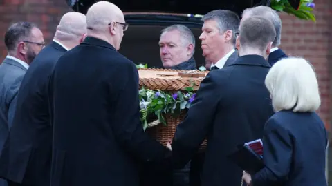 PA Media Pall bearers carry the casket into the Requiem Mass for former Rochdale MP and Greater Manchester mayor Tony Lloyd, at St Hugh Of Lincoln RC Church in Stretford, Manchester, following his death on January 17. Picture date: Friday February 16, 2024.