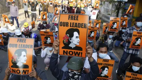 Getty Images Protesters hold up placards demanding the release of detained Myanmar civilian leader Aung San Suu Kyi