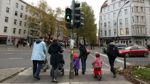 Getty Images A group of parents and children cross the street in the former East German neighbourhood of Prenzlauer Berg