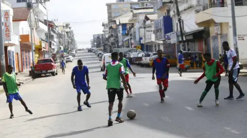 EPA People playing football in the streets of Monrovia