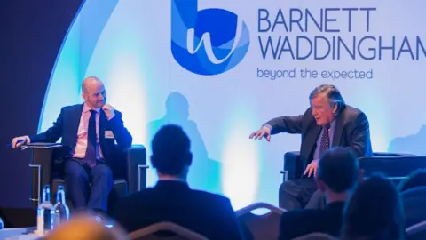 Barnett Waddingham Marcus on stage with politician Kenneth Clarke