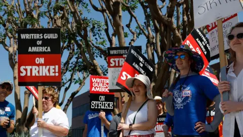 EPA-EFE/REX/Shutterstock Picketers outside NBCUniversal's Barham Gate in Los Angeles last month