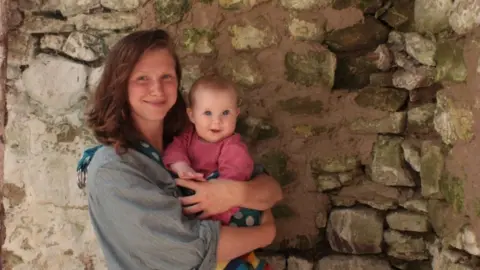 Rose Mai Celeste Rose Mai Celeste holding her baby