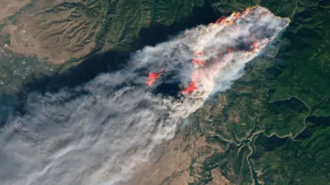 NASA This NASA Earth Observatory handout image taken on November 8, 2018 and released on November 10, 2018 shows the Camp Fire burning in Paradise, California