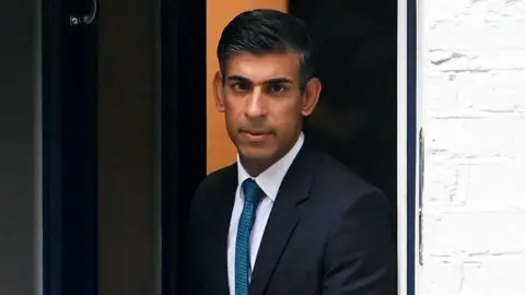 Reuters Rishi Sunak pictured outside his home on Friday