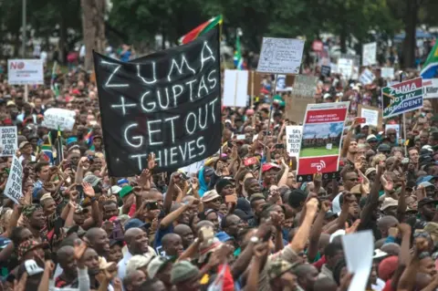 AFP/Getty Images Tens of thousands of South Africans from various political and civil society groups march to the Union Buildings to protest against South African president and demand his resignation on April 7, 2017 in Pretoria.