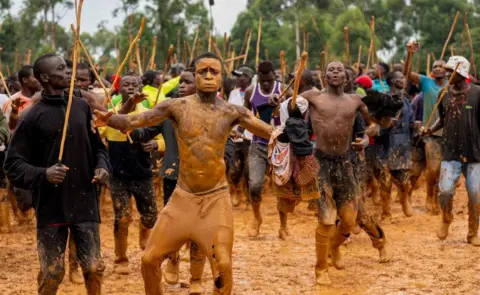 Fredrik Lerneryd/Getty Images Supporters dance and chant in between matches during a traditional bullfighting tournament in Malinya Stadium, near Kakamega - Monday January 2024