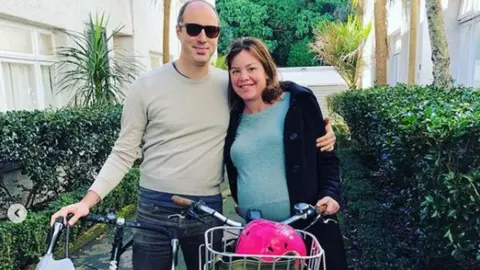 Julie Genter/Instagram Julie Genter poses with her partner Peter and their bikes
