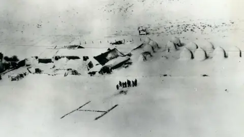 Alamy Aerial image of a far in snow