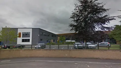 Google school buildings with a large tree