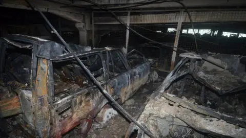 Merseyside Fire and Rescue/Reuters Burned out cars