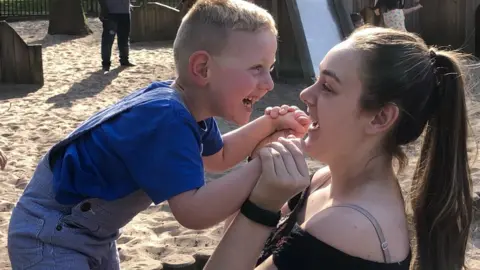 Family photo Christian and Jade playing in the park together