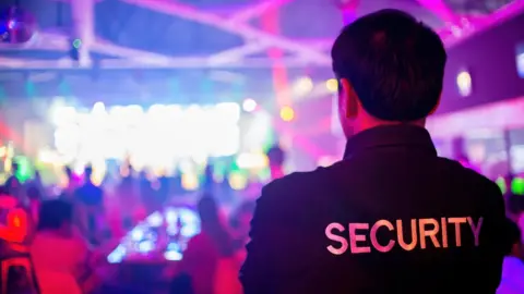 Getty Images Security guard in a night club