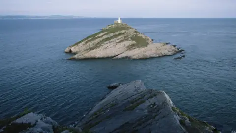 Getty Images Mumbles Lighthouse at high tide