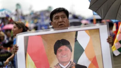 Reuters A supporter holds a photo of Bolivia's former President Evo Morales during his caravan after returning to the country, in Chimore, Bolivia November 11, 2020.