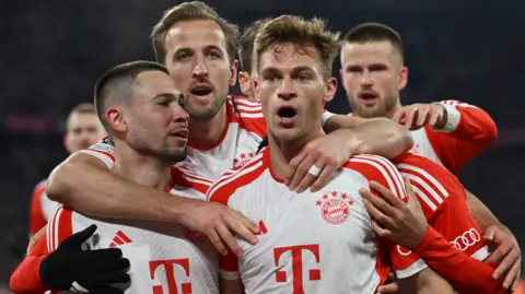 Bayern Munich's players celebrate scoring against Arsenal in the Champions League